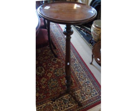 A Mahogany Torchere on a tripod base.