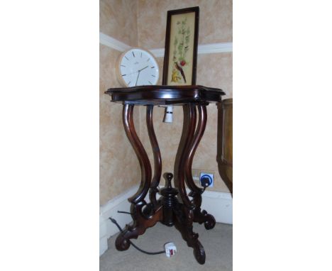 A Mahogany Side Table, 20th Century, having a highly carved base, together with a textured print (2).