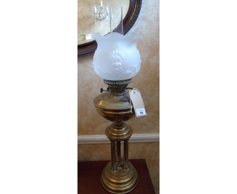 A Late 19th/Early 20th Century Brass Oil Lamp raised on three reeded columns and circular plinth.