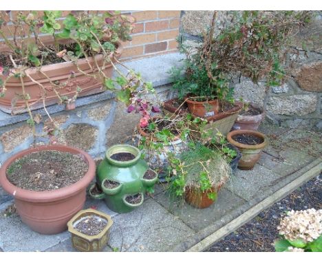 Nine Various Planters to include a Chinese fishbowl jardinière and a green glazed strawberry planter (9).