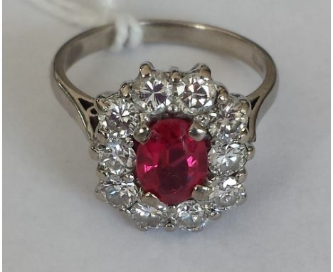 An 18ct. Gold Diamond and Ruby Cluster Ring. Size M. Ruby 1 carat, Diamond 2 carats approx.