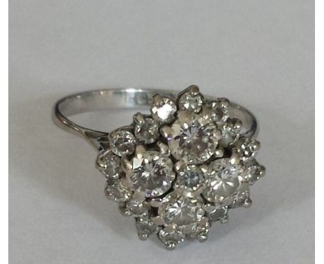 An 18ct. Diamond Cluster Ring. Size K.