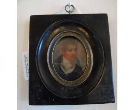A Miniature Oval Print of A Gentleman In A Black Frame.