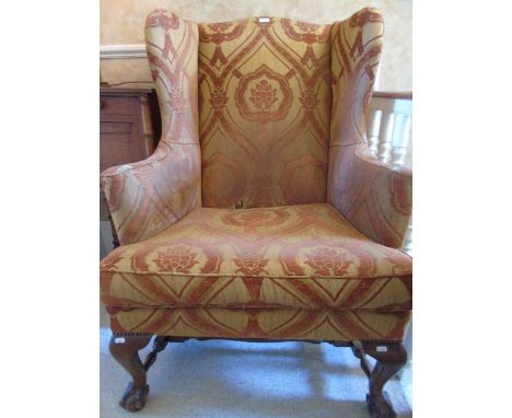 A Stained Beech Wing Frame Armchair in the Georgian style - fully upholstered in brick and gold coloured damask fabric, havin