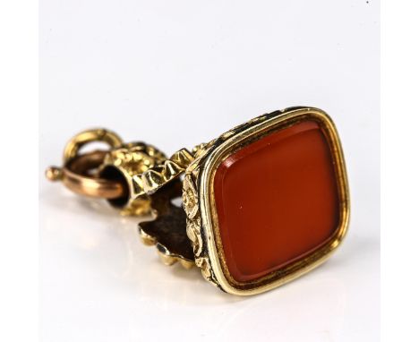An Antique carnelian seal fob, unmarked yellow metal settings, with shell and floral lattice decoration and plain hardstone, 