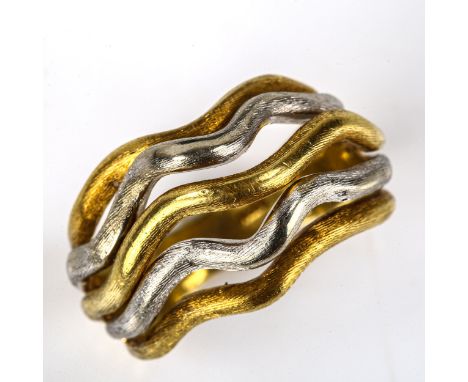 An 18ct yellow and white gold abstract band ring, wavy textures openwork design, setting height 14.8mm, size O, 7.5gNo damage