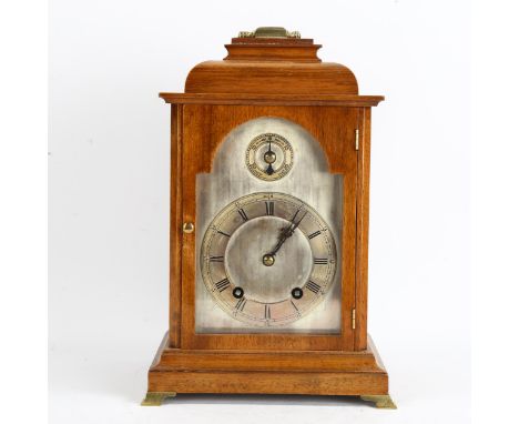 A small German light oak-cased 8-day bell-top bracket clock, silvered dial with Roman numeral hour markers and movement strik
