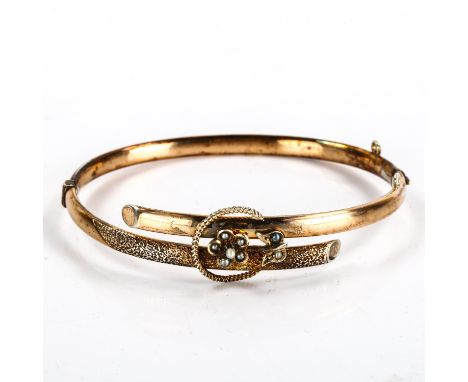 A Victorian gold plated pearl crossover hinged bangle, setting height 9.3mm, internal dimensions 5.5cm x 5cm, 6.5gPlating rub