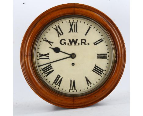 A light oak-cased GWR railway station circular dial 30-hour wall clock, white enamel dial with Roman numeral hour markers, di