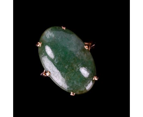 A large 9ct gold jade panel ring, set with oval cabochon jade, measuring 23.65mm x 15.18mm x 6.17mm, size Q, 6.8gNo damage or