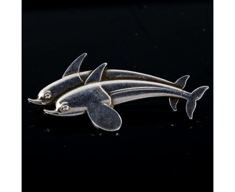 GEORG JENSEN - a Danish stylised sterling silver double-dolphin brooch, designed by Arno Malinowski, model no. 317, length 41