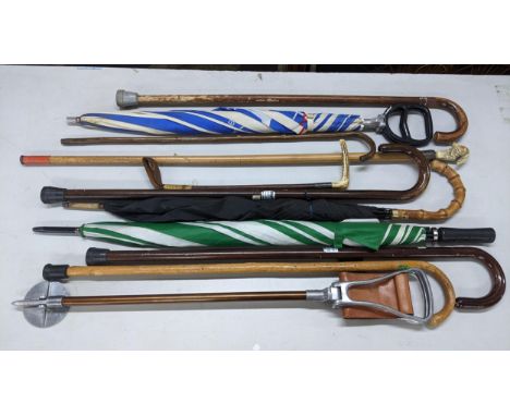 A mixed lot of mainly walking sticks to include an early 20th century silver collared walking stick with a resin birds headLo