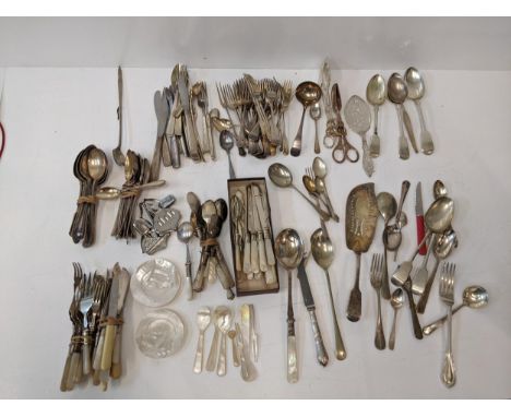 A collection of silver plated flatware to include two pairs of tongs, a fish slice along with mother of pearl handled flatwar