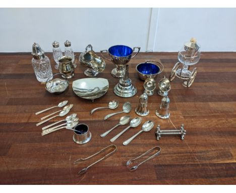 A collection of silver plated items to include salt and pepper shakers, a twin handled sugar pot, flatware and other items Lo