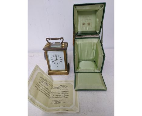 A Charles Frodsham carriage clock, five window brass case, white enamel face with Roman numerals, moon hands, with Playboy in