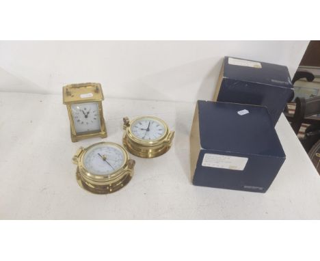 A mixed lot to include a brass cased 8-day carriage clock together with two brass cased Wempe Schiffsuhr ship clocks with box