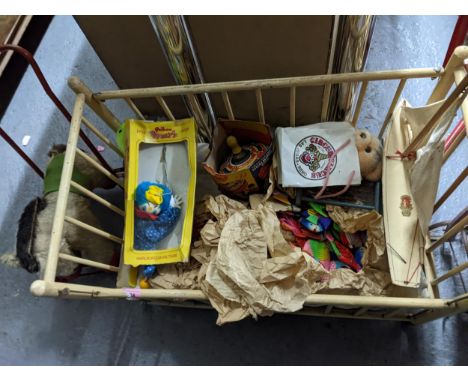 A mixed lot of toys and games to include various boxed vintage jigsaw puzzles, a doll's cot, a Bowman toy racing yacht, a box