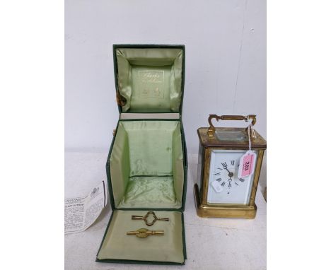 A Charles Frodsham carriage clock, five window brass case, white enamel face with Roman numerals, moon hands, with Playboy in