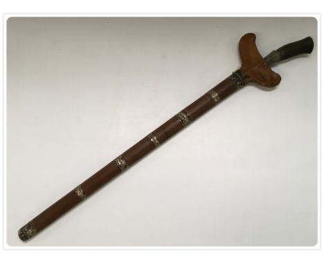 AN EASTERN SHORT SWORD WITH PLATTED GRIP, WHITE METAL FERULE, SHAPED BLADE WITH SAW TOOTH HILT, SCABBARD MADE FROM YEW WOOD B