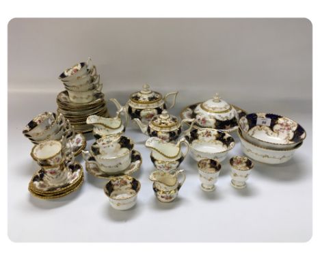 A COALPORT PART TEA SERVICE DECORATED WITH FLOWERS, A BLUE GROUND AND GILDING (44 PIECES) 
