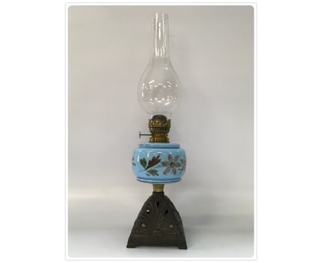 ONE INCH SLIP-WICK OIL LAMP. CAST BASE DATED 1905, BLUE GLASS HAND DECORATED FONT (In-house packing unavailable for this lot)