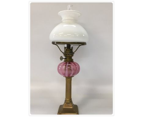 CRANBERRY GLASS PIANO OIL LAMP WITH 6 LINE KOSMOS BURNER, MOUNTED ON AN OLD BRASS CANDLESTICK (In-house packing unavailable f