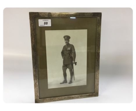 A PHOTOGRAPH OF AN ARMY OFFICER IN A SILVER FRAME 