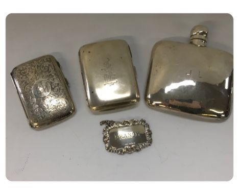 A SILVER HIP FLASK, TWO SILVER CIGARETTE CASES ALONG WITH A SILVER BRANDY LABEL 