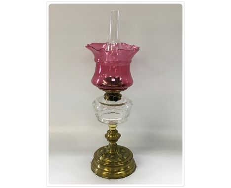 DUPLEX OIL LAMP, BRASS BASE AND STEM, CUT GLASS FONT, DAMAGED CRANBERRY SHADES (In-house packing unavailable for this lot) 