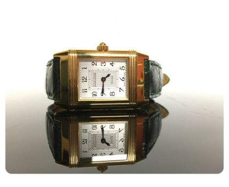 A JAEGER-LECOULTRE LADY'S WRIST WATCH, 18CT GOLD CASE, ON A LEATHER STRAP WITH 18CT GOLD MOUNTS, THE DIAL INSCRIBED "REVERSO"
