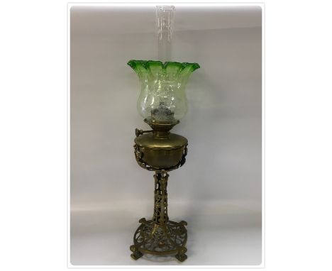 A VERITAS CENTRAL DRAUGHT 50 CANDLE POWER OIL LAMP WITH AN ELABORATE BASE AND COLUMN. BRASS FONT, BEST QUALITY GREEN TULIP SH