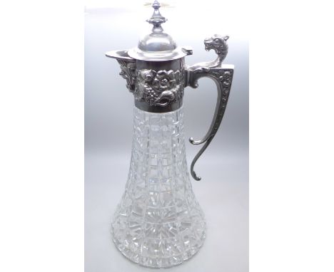 A silver topped claret jug with embossed design, Sheffield 1985, 30cm