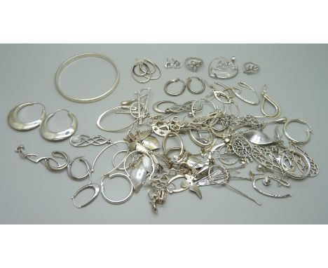 A collection of silver, white metal and plated jewellery, mostly earrings, together with a silver bangle