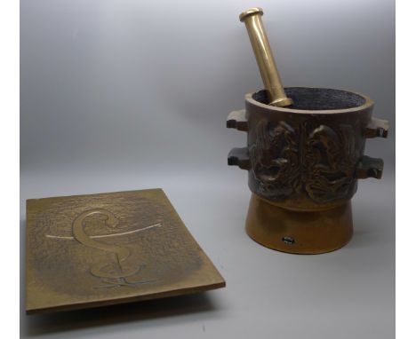 A heavy bronze pestle and mortar and a bronze tray with anchor decoration 