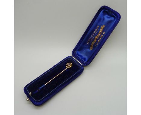 A 15ct gold ruby set stick pin, 1.2g, 5.7cm