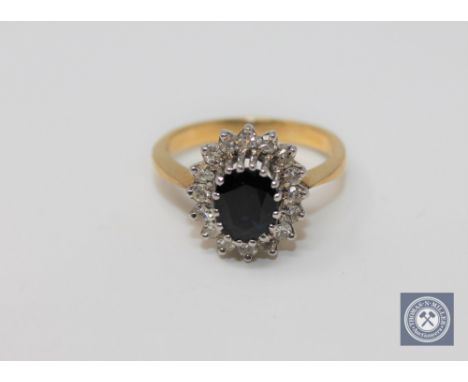 An 18ct gold sapphire and diamond cluster ring, size P
