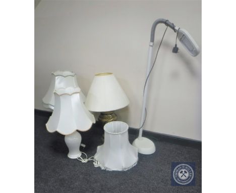 A brass table lamp with shade together with two other table lamps with shades and angle poised reading lamp