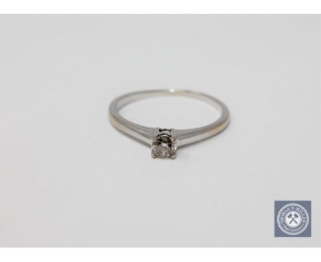 An 18ct white gold round cut diamond solitaire ring, approximately 0.25ct, size P.