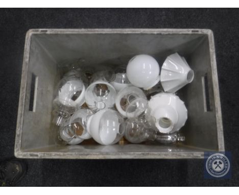 A box of oil lamp chimneys and glass shades 
