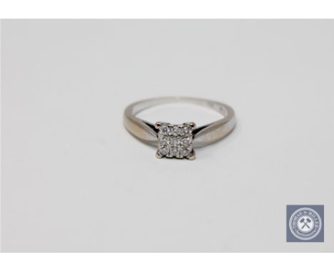 An 18ct white gold six stone diamond square set cluster ring, approximately 0.14ct, size K 1/2.