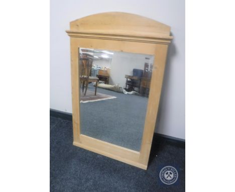 An early 20th century pine framed bevelled mirror 