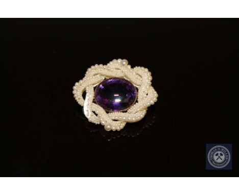 A Victorian amethyst and pearl brooch in gold mount