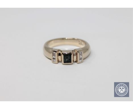 A 14ct white gold diamond and emerald ring, approximately 0.12ct, size J.