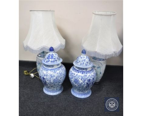 A pair of Chinese style pottery table lamps with shades together with a pair of blue and white lidded vases