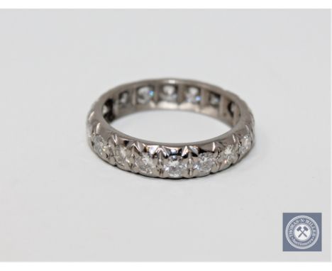 A diamond full eternity ring in white metal, approximately 1ct.