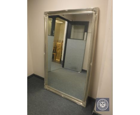 An ornate silvered mirror, 105 cm x 167 cm 