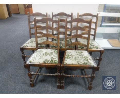 A 1930's oak pull out dining table together with a set of five oak ladder back chairs