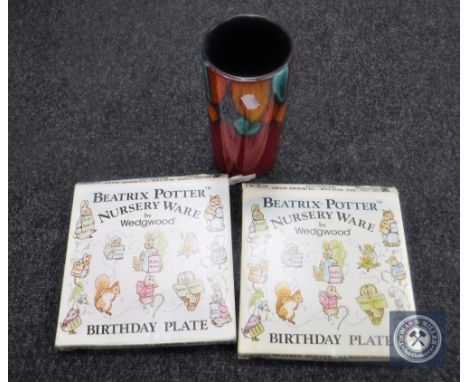 A Poole pottery vase and two boxed Beatrix Potter plates by Wedgwood 