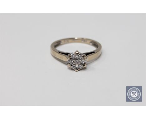 An 18ct gold diamond flower cluster ring, approximately 0.25ct, size L 1/2.
