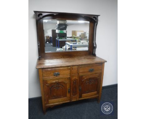 An Edwardian oak Arts &amp; Crafts mirror back sideboard